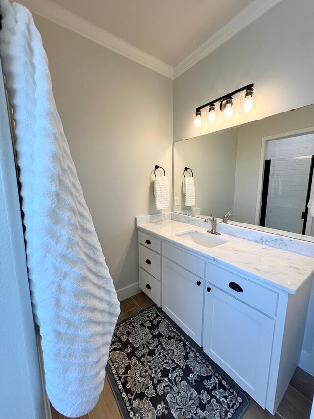 bathroom with crown molding and vanity