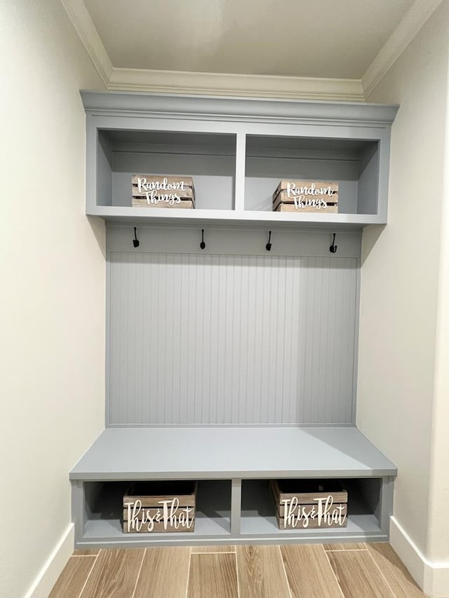 mudroom with hardwood / wood-style flooring and ornamental molding