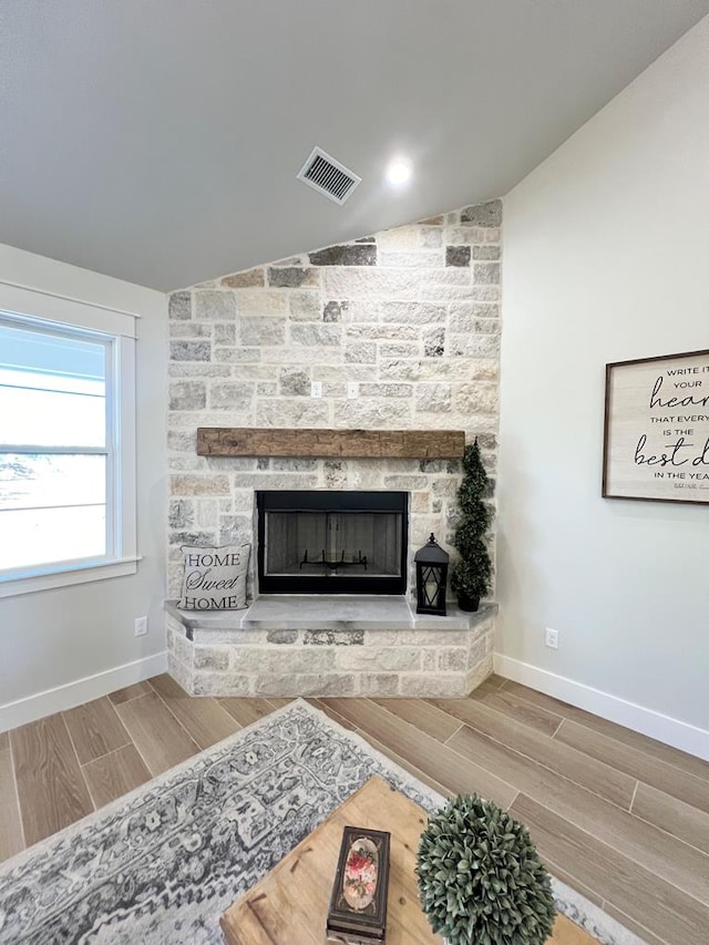 interior details featuring a stone fireplace