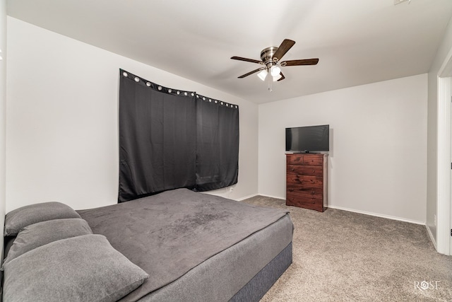 bedroom featuring a ceiling fan, carpet, and baseboards