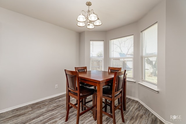 dining room with an inviting chandelier, wood finished floors, and baseboards