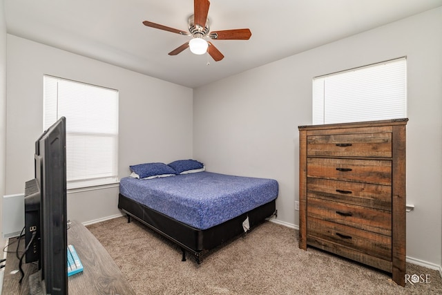 bedroom featuring carpet floors, multiple windows, and baseboards