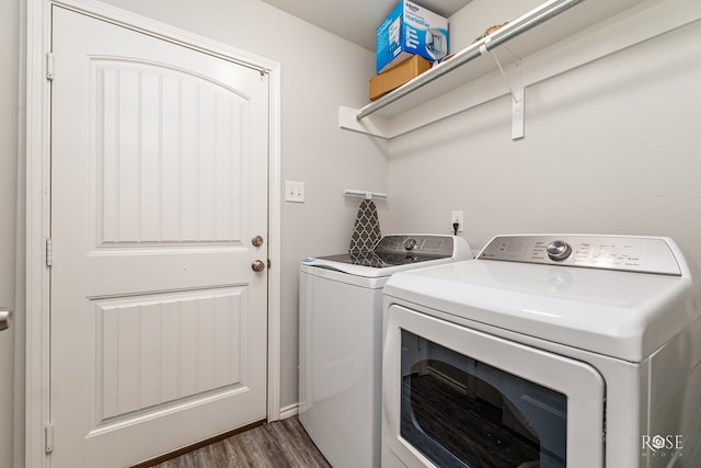 laundry area featuring dark wood-style floors, washing machine and dryer, and laundry area