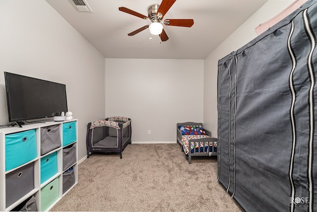 bedroom with baseboards, visible vents, a ceiling fan, and light colored carpet