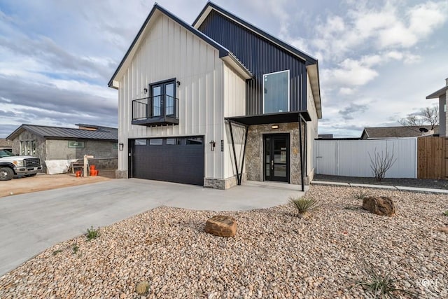 modern farmhouse style home with a garage and a balcony