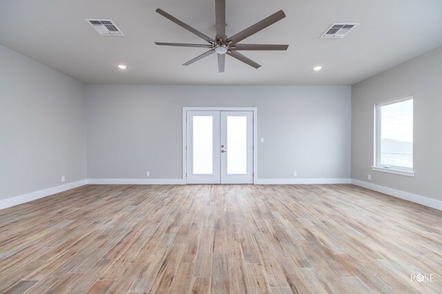 unfurnished room featuring french doors, ceiling fan, and light hardwood / wood-style flooring