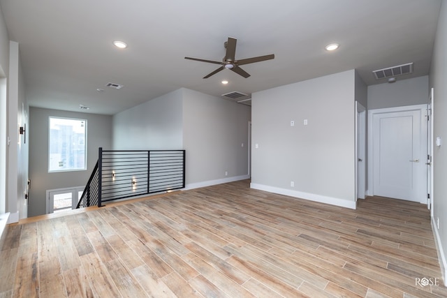 spare room featuring ceiling fan and light wood-type flooring