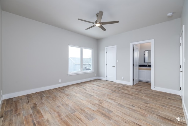 unfurnished bedroom with ceiling fan, ensuite bath, and light hardwood / wood-style flooring