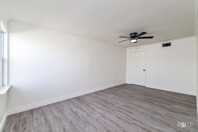 4815 Bowie St, San Angelo, TX 76903 - unfurnished room with ceiling fan, wood finished floors, baseboards, and crown molding