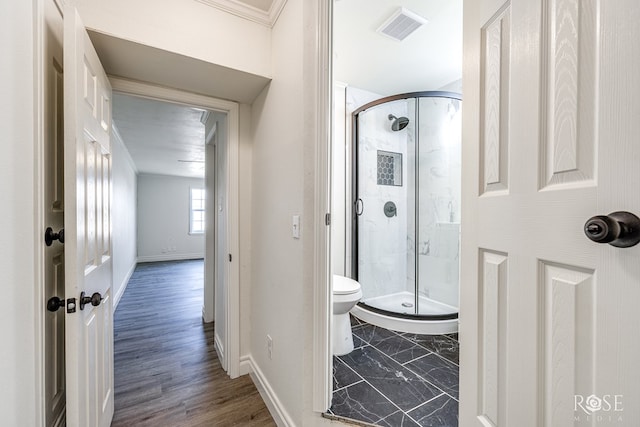 4815 Bowie St, San Angelo, TX 76903 - bathroom featuring toilet, a shower stall, baseboards, and crown molding