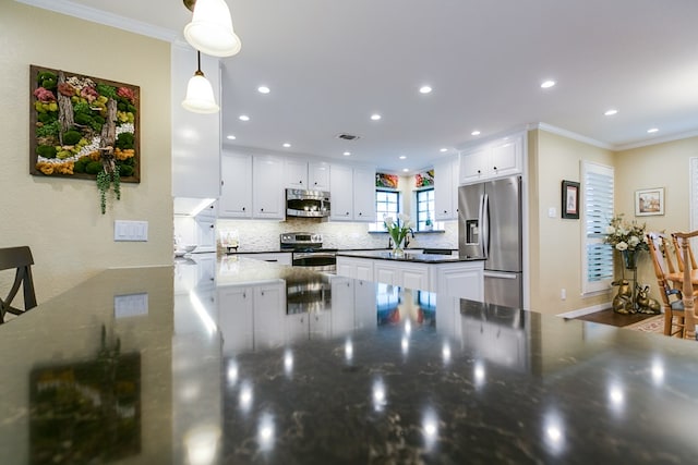 kitchen featuring white cabinetry, tasteful backsplash, appliances with stainless steel finishes, and crown molding