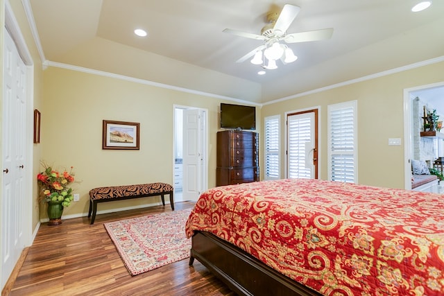 bedroom featuring crown molding, recessed lighting, baseboards, a raised ceiling, and wood finished floors