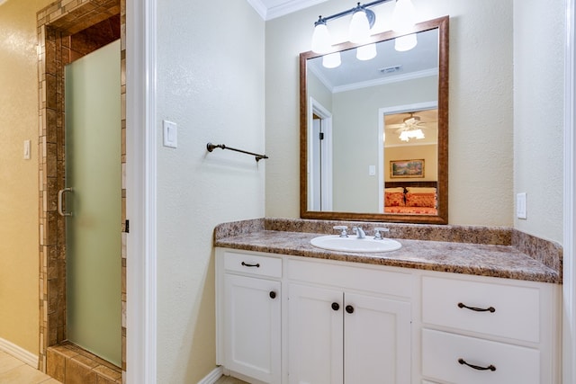 full bath with vanity, crown molding, a textured wall, a shower stall, and visible vents