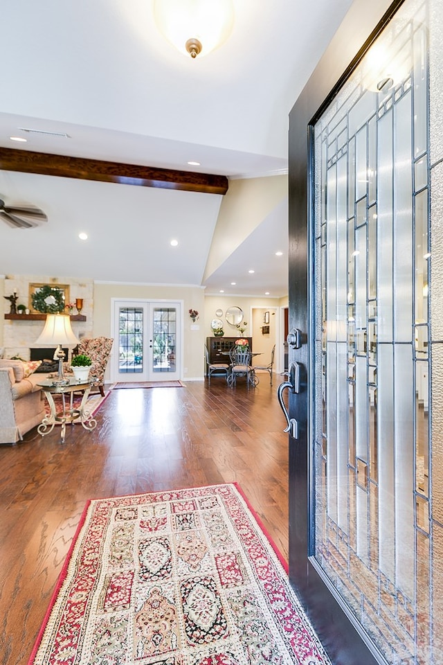 foyer entrance with vaulted ceiling with beams, wood finished floors, and recessed lighting