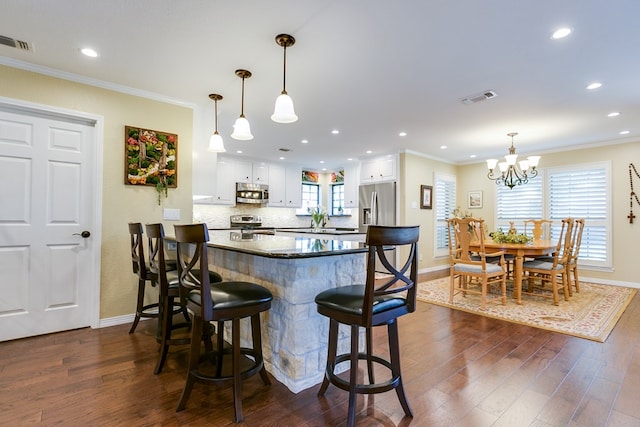 kitchen featuring visible vents, stainless steel appliances, and dark wood finished floors