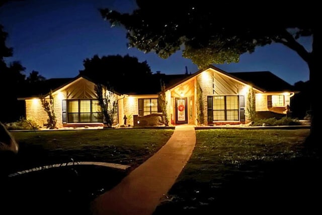 mid-century home with a yard