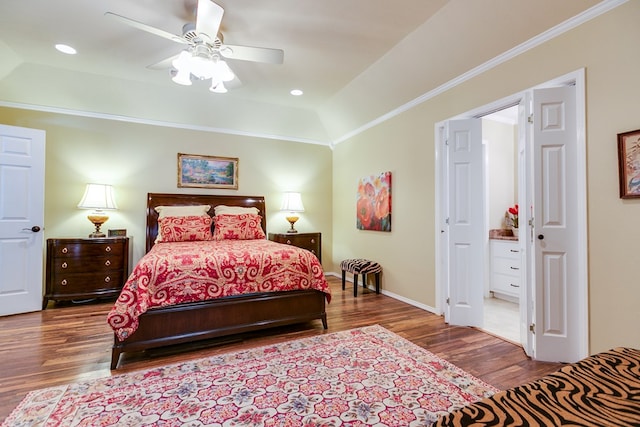 bedroom with a tray ceiling, recessed lighting, wood finished floors, and ornamental molding