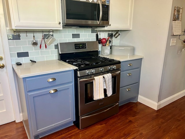 2708 A & M Ave, San Angelo, TX 76904 - kitchen featuring appliances with stainless steel finishes, baseboards, backsplash, dark wood-type flooring, and light countertops
