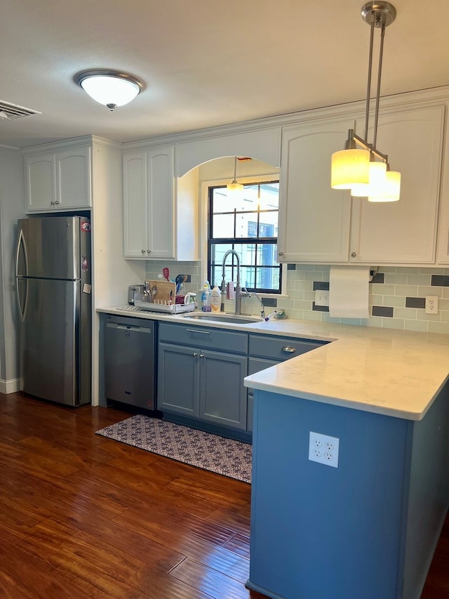 2708 A & M Ave, San Angelo, TX 76904 - kitchen featuring stainless steel appliances, a sink, dark wood-type flooring, and backsplash