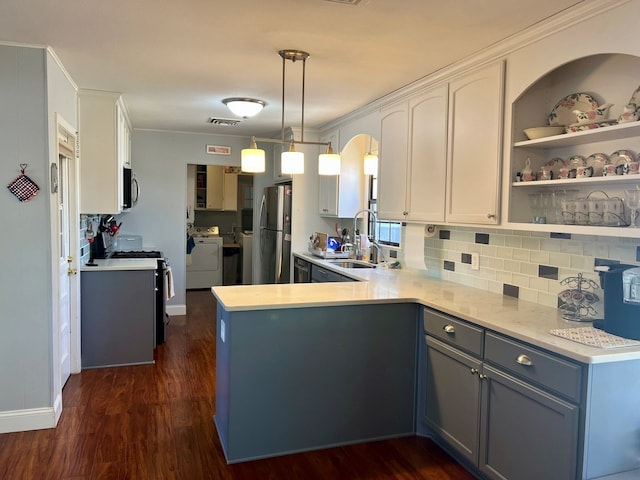 2708 A & M Ave, San Angelo, TX 76904 - kitchen featuring appliances with stainless steel finishes, a sink, washer and dryer, and light countertops