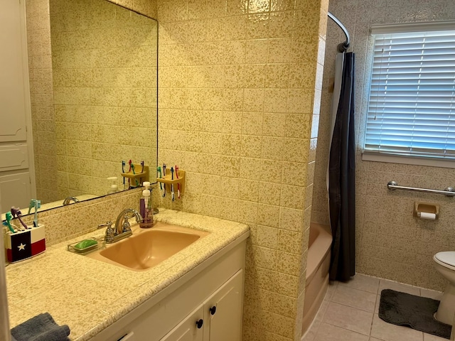 2708 A & M Ave, San Angelo, TX 76904 - bathroom featuring tile walls, vanity, tile patterned flooring, shower / tub combo with curtain, and toilet