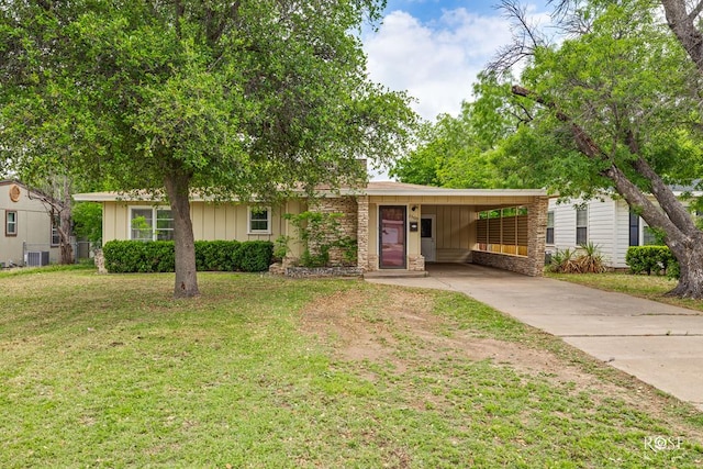 2609 W Beauregard Ave, San Angelo, TX 76901 - single story home featuring an attached carport, a front lawn, board and batten siding, central AC unit, and driveway
