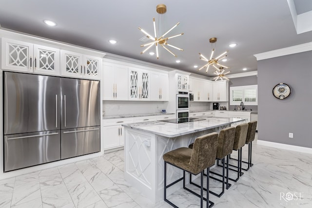 1609 Club House Ln, San Angelo, TX 76904 - kitchen with stainless steel refrigerator, a chandelier, crown molding, a sink, and light marble finish flooring