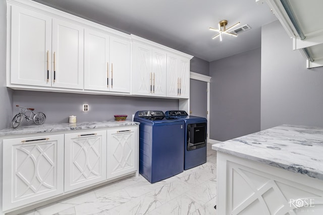 1609 Club House Ln, San Angelo, TX 76904 - laundry room with cabinet space, light marble finish floors, and washer and clothes dryer