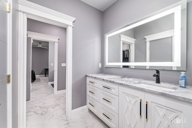 1609 Club House Ln, San Angelo, TX 76904 - bathroom with marble look tile flooring, vanity, baseboards, and a ceiling fan