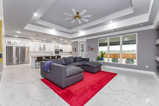 1609 Club House Ln, San Angelo, TX 76904 - living room featuring light marble finish flooring, a tray ceiling, ceiling fan, baseboards, and recessed lighting