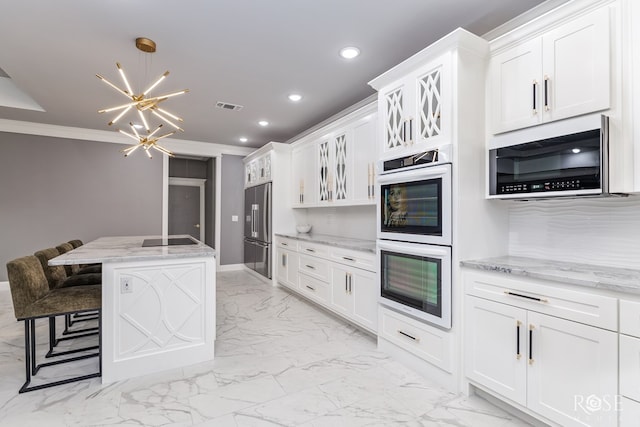 1609 Club House Ln, San Angelo, TX 76904 - kitchen with white double oven, high end refrigerator, a chandelier, light marble finish floors, and recessed lighting