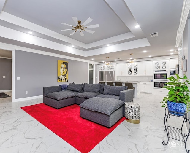 1609 Club House Ln, San Angelo, TX 76904 - living room featuring light marble finish floors, a raised ceiling, a ceiling fan, recessed lighting, and baseboards