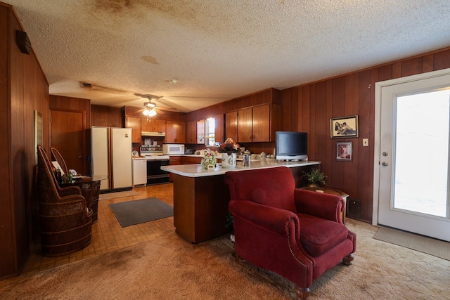 109 Live Oak Dr, Ozona, TX 76943 - kitchen featuring fridge, white microwave, electric range, light countertops, and a peninsula