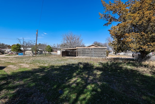 109 Live Oak Dr, Ozona, TX 76943 - view of grassy yard featuring a carport