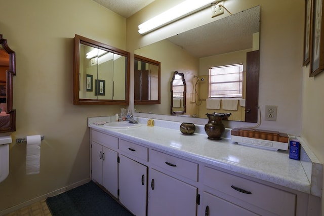 109 Live Oak Dr, Ozona, TX 76943 - bathroom with a textured ceiling and vanity