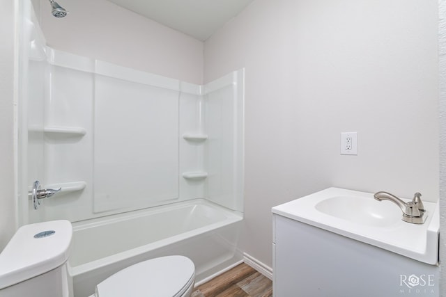 full bathroom with hardwood / wood-style flooring, vanity, shower / bathtub combination, and toilet