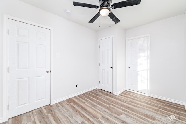 unfurnished bedroom featuring ceiling fan and light wood-type flooring