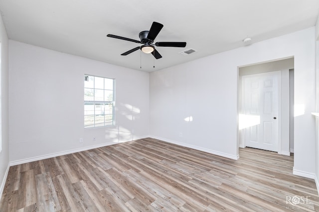 spare room featuring light hardwood / wood-style flooring and ceiling fan