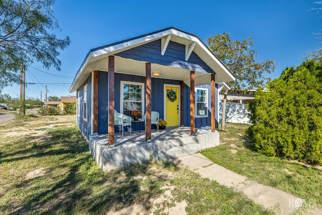 bungalow-style home featuring a porch and a front lawn