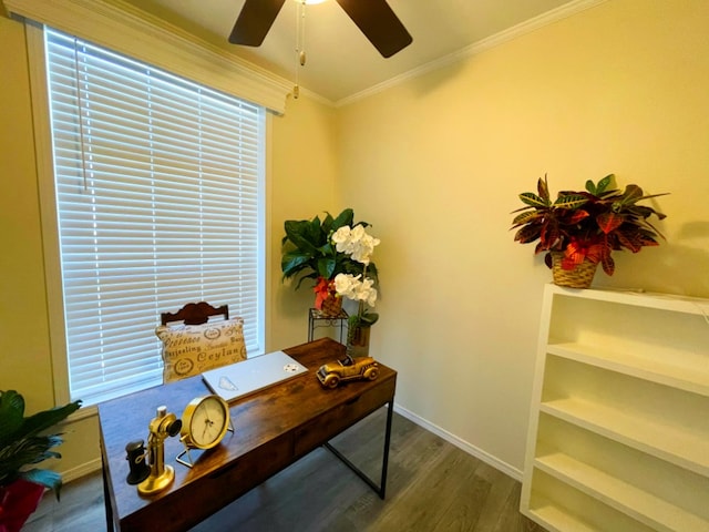 office space with baseboards, ceiling fan, wood finished floors, and crown molding