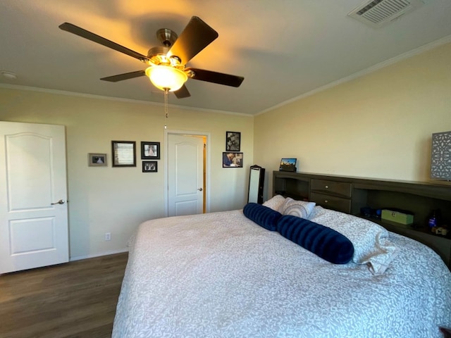 bedroom featuring a ceiling fan, visible vents, crown molding, and wood finished floors