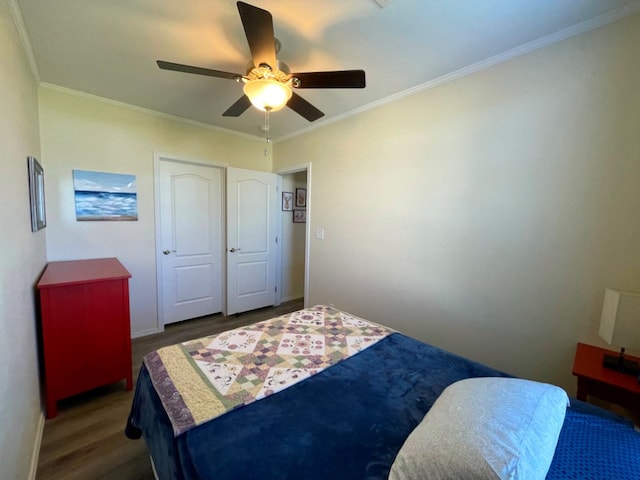 bedroom featuring a ceiling fan, crown molding, baseboards, and wood finished floors