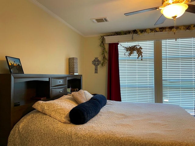 bedroom with vaulted ceiling, ornamental molding, visible vents, and a ceiling fan