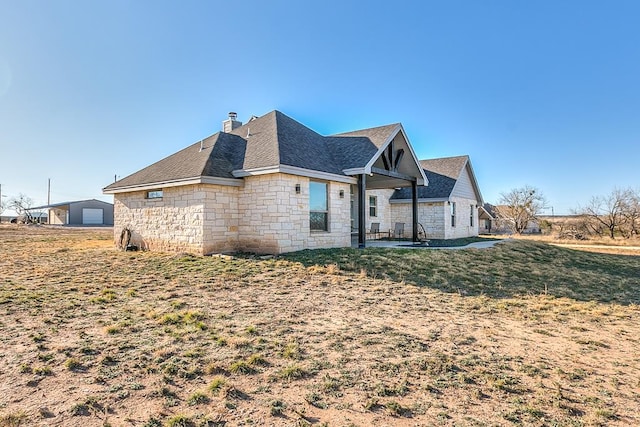 view of side of property with a yard