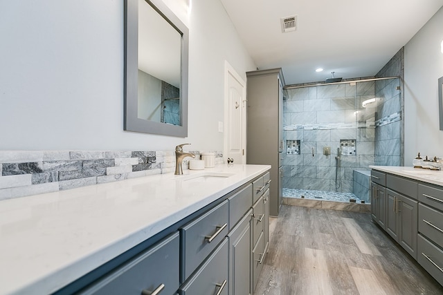 bathroom with vanity, hardwood / wood-style floors, and a shower with shower door