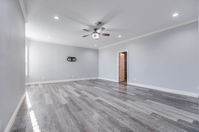 spare room featuring crown molding, light hardwood / wood-style floors, and ceiling fan