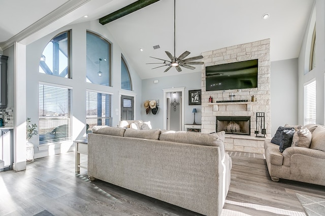 living room with hardwood / wood-style flooring, ceiling fan, beam ceiling, high vaulted ceiling, and a fireplace