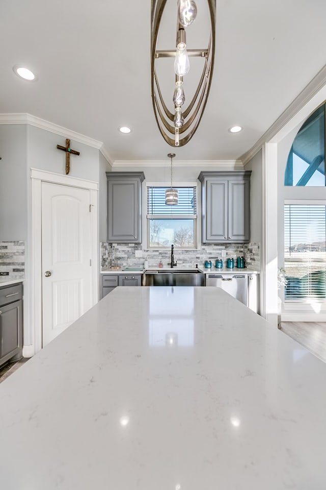 kitchen featuring stainless steel dishwasher, a healthy amount of sunlight, sink, and gray cabinetry