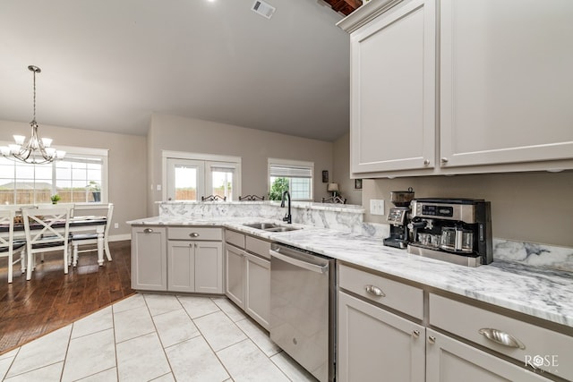 5988 Bridlewood Ct, San Angelo, TX 76904 - kitchen featuring vaulted ceiling, dishwasher, visible vents, a sink, and a peninsula