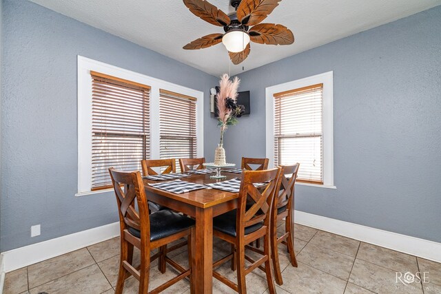 tiled dining area with ceiling fan